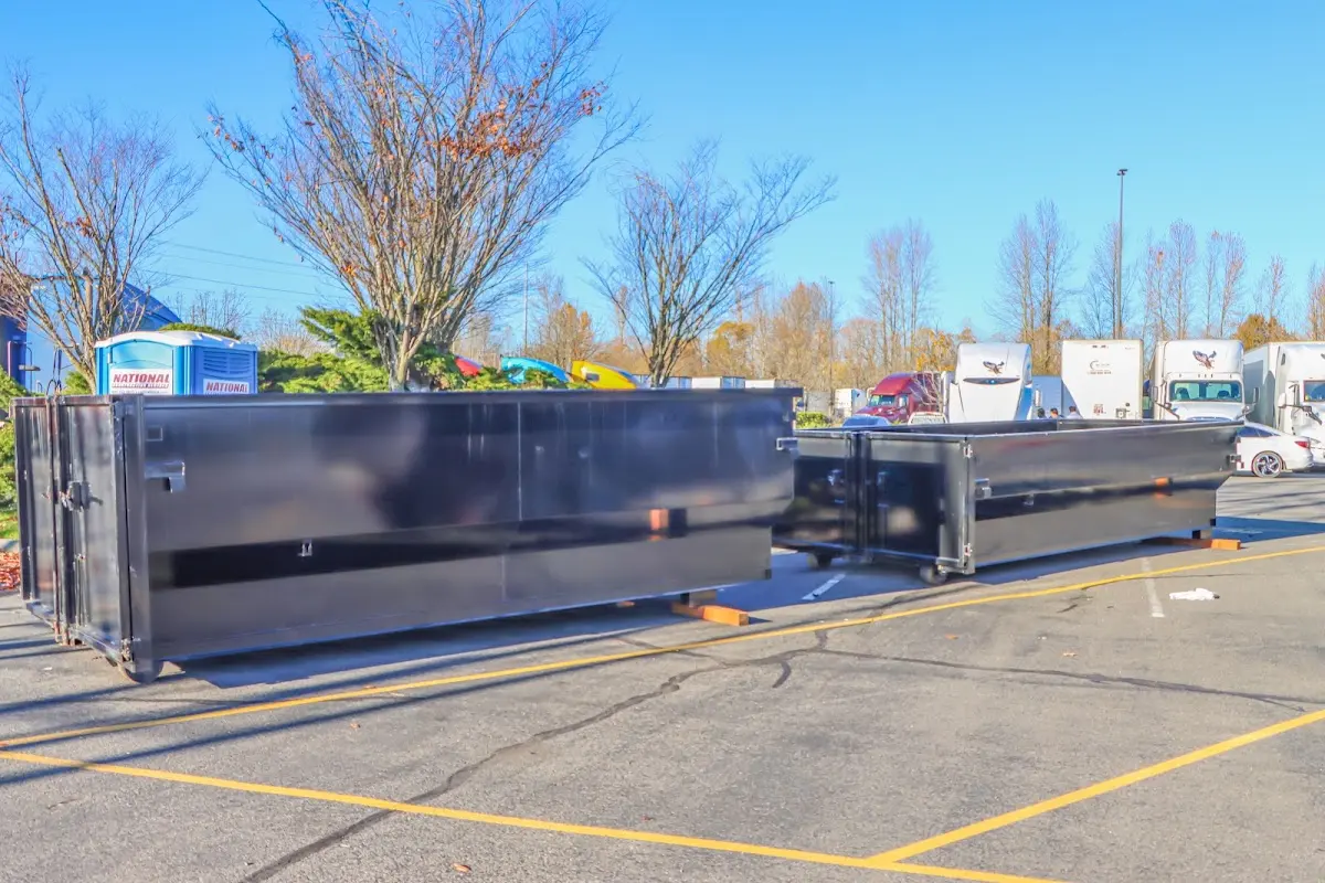 Professional dumpster rental service with roll-off container on residential driveway in Rainbow Springs